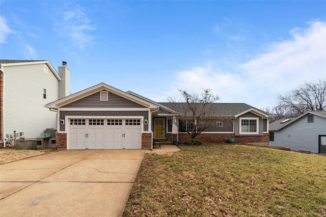 view of front of home featuring a front yard, an attached garage, brick siding, and driveway