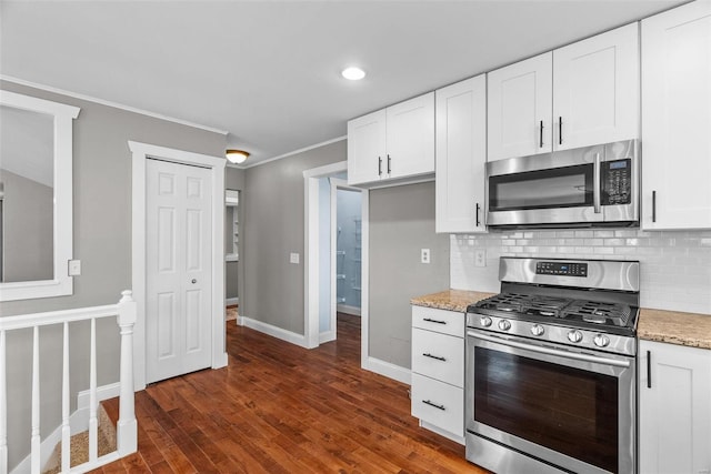 kitchen featuring dark wood finished floors, white cabinets, backsplash, and stainless steel appliances