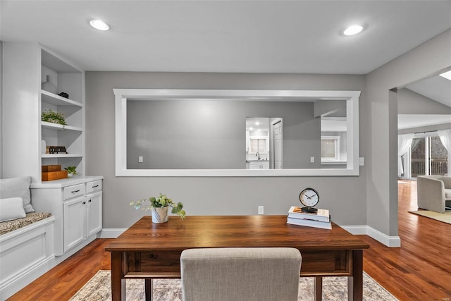 office featuring recessed lighting, wood finished floors, baseboards, and a sink