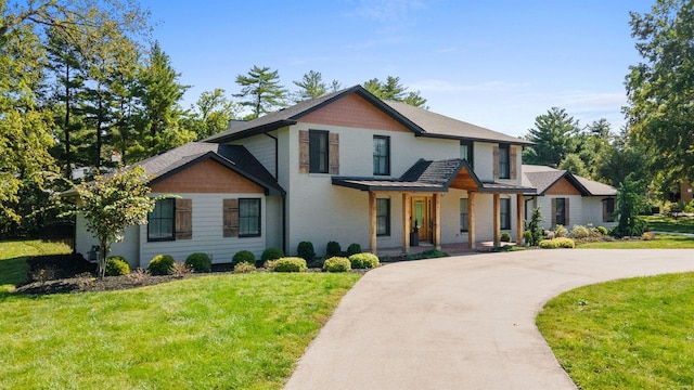 view of front of property with covered porch and a front lawn