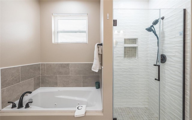 bathroom featuring a whirlpool tub and a stall shower