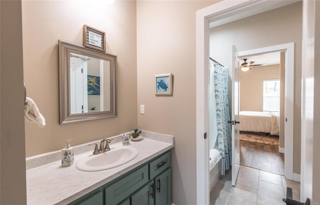 bathroom featuring curtained shower, ensuite bath, tile patterned flooring, and vanity