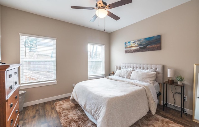 bedroom with dark wood-style floors, ceiling fan, and baseboards