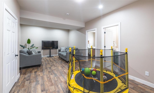 living room featuring dark wood finished floors and baseboards