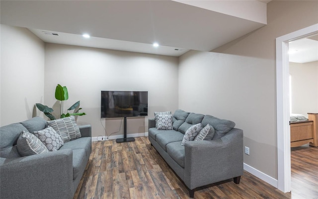 living room with recessed lighting, dark wood finished floors, visible vents, and baseboards