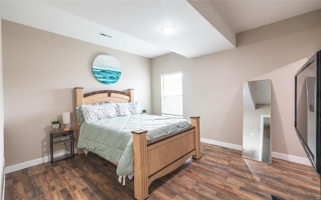 bedroom with visible vents, dark wood finished floors, and baseboards