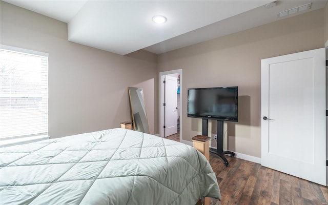 bedroom featuring dark wood-style flooring, visible vents, and baseboards