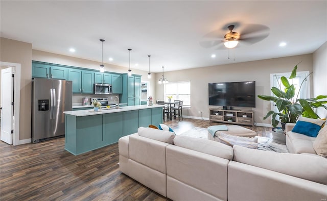 living room featuring baseboards, dark wood finished floors, a ceiling fan, and recessed lighting