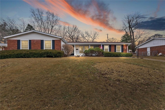 ranch-style house featuring a lawn