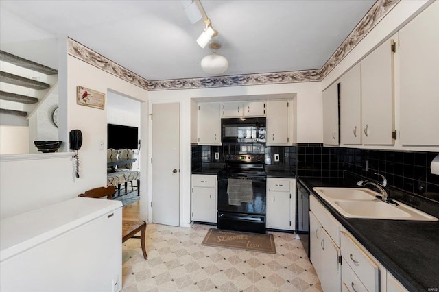 kitchen featuring light floors, a sink, backsplash, black appliances, and dark countertops