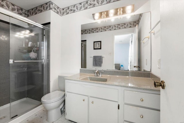 full bathroom featuring toilet, vanity, and a shower stall