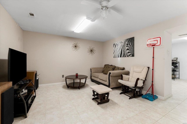 living room featuring baseboards, visible vents, and ceiling fan