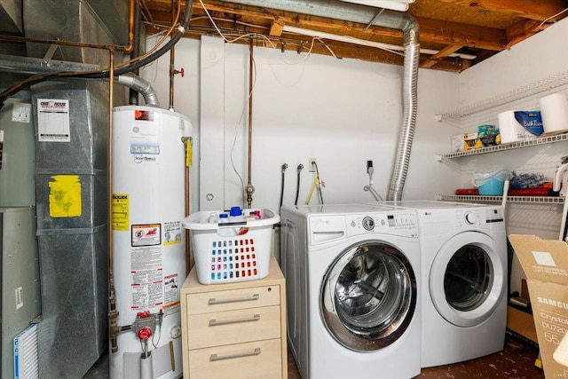 clothes washing area with laundry area, water heater, washing machine and clothes dryer, and heating unit