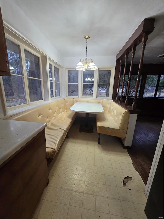 sunroom / solarium with a chandelier