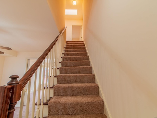 stairs with carpet flooring, ceiling fan, and baseboards