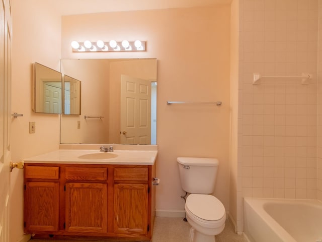 bathroom featuring washtub / shower combination, vanity, toilet, and baseboards