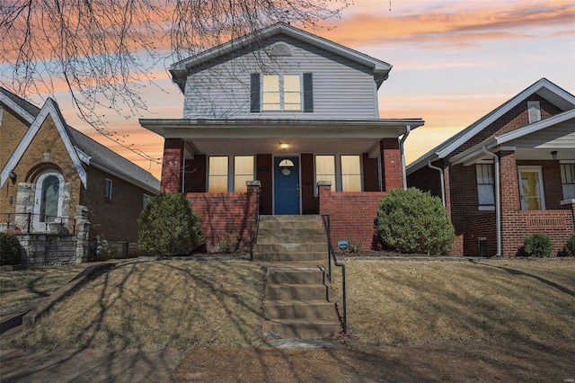 view of front of home featuring brick siding and covered porch