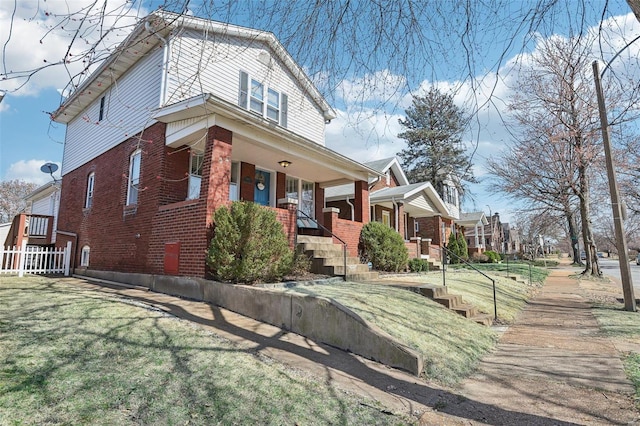 view of property exterior with brick siding and a porch