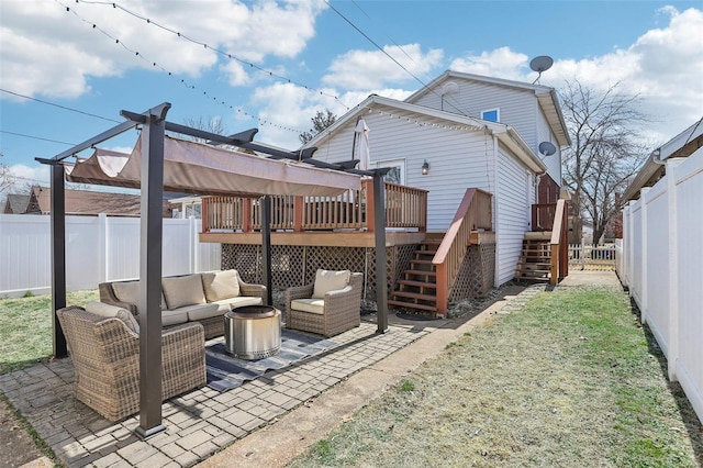 back of house with an outdoor living space, stairway, a deck, and a fenced backyard