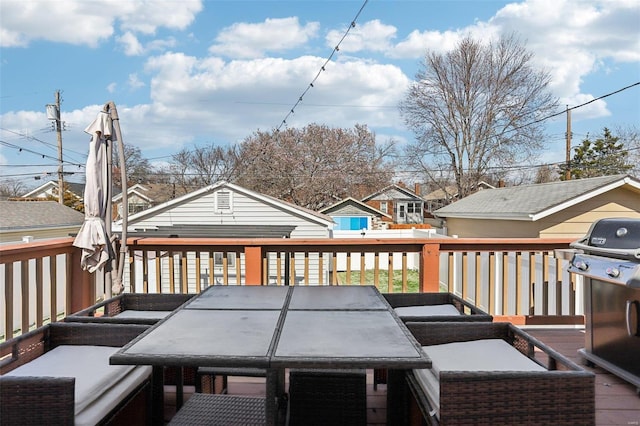 deck with outdoor dining area and a grill