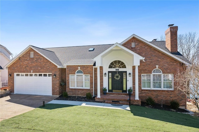 view of front of home with a garage, brick siding, and driveway