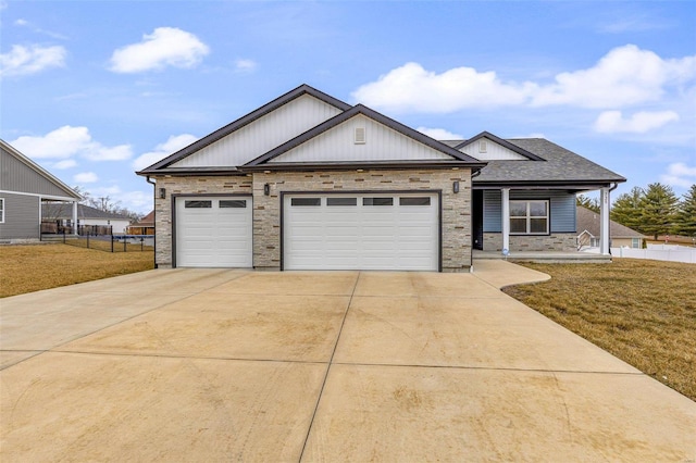 view of front of house featuring a garage, a front yard, and covered porch