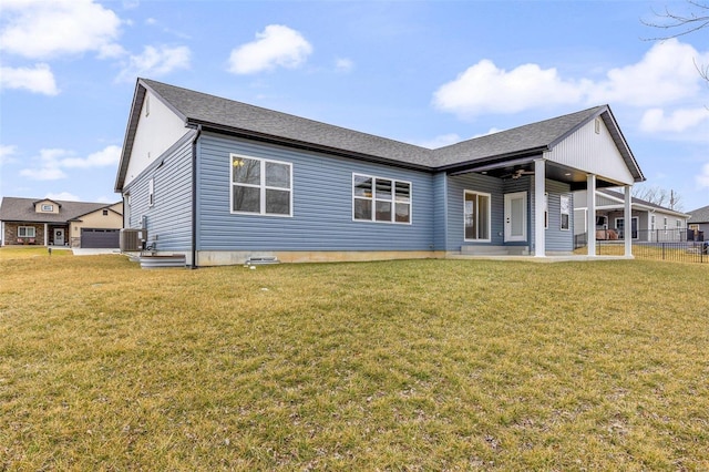 rear view of house with cooling unit, a lawn, and a patio area