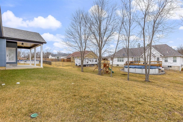 view of yard with a covered pool, a patio area, and a playground