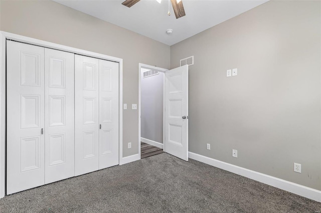 unfurnished bedroom with dark carpet, a closet, and ceiling fan