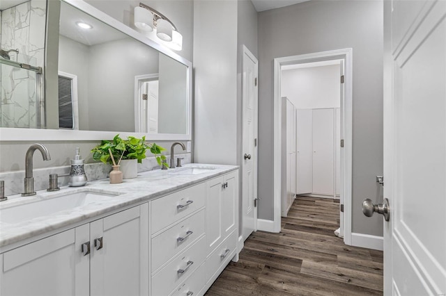 bathroom with vanity, wood-type flooring, and a shower with shower door