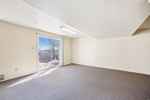 empty room featuring baseboards and carpet floors