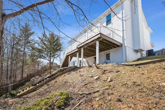 view of home's exterior featuring stairs and a deck