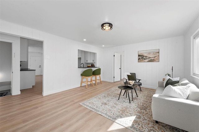 living area featuring light wood-type flooring and baseboards