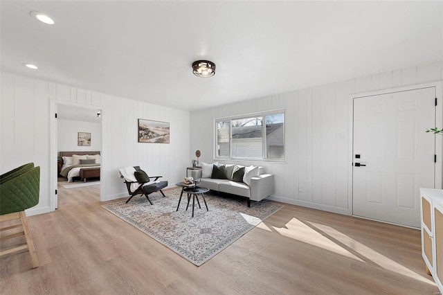 living room with baseboards and light wood-type flooring