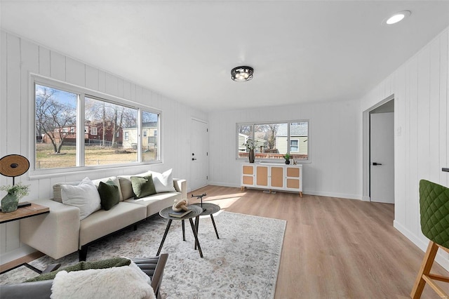 living room with light wood-style flooring and baseboards