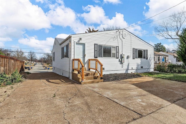 view of front of home featuring fence and crawl space