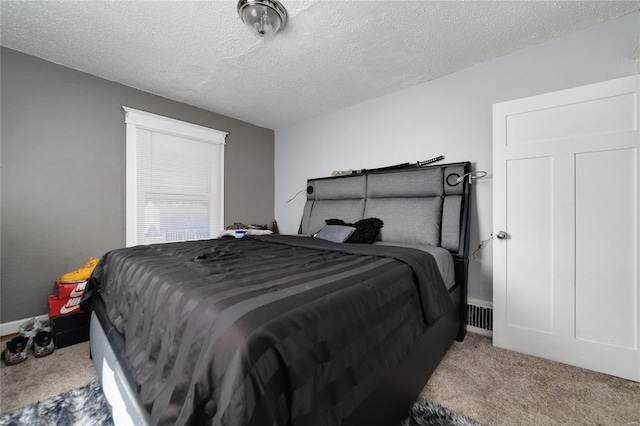 carpeted bedroom featuring a textured ceiling