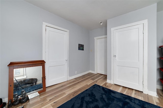 bedroom with baseboards and light wood-style floors