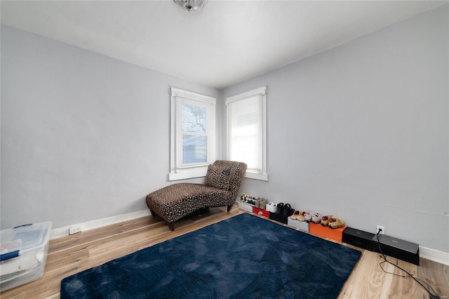 bedroom featuring baseboards and wood finished floors