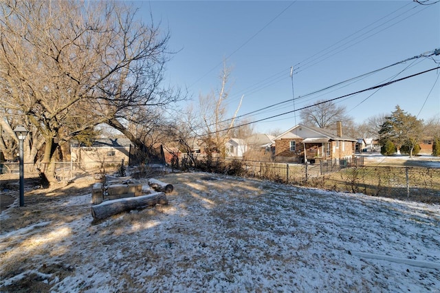 yard layered in snow featuring fence