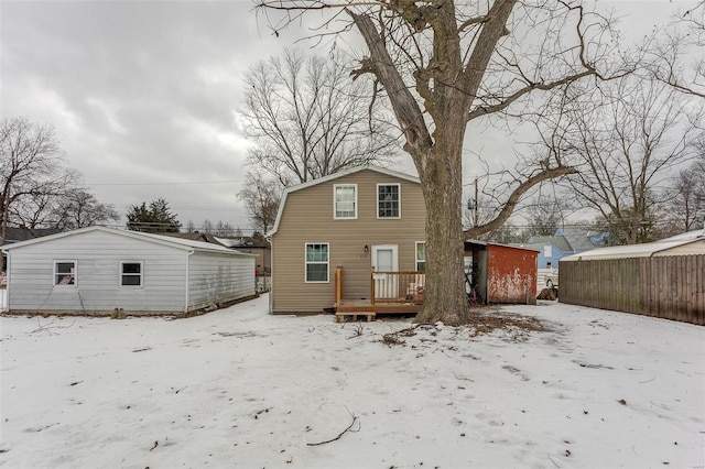 view of snow covered rear of property