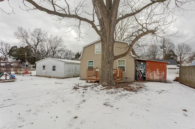 snow covered property with a deck