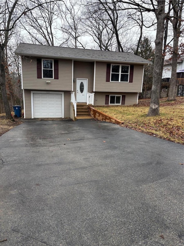 bi-level home with driveway and a garage