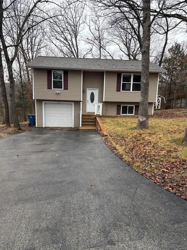 bi-level home with driveway and an attached garage