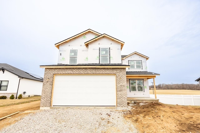 view of front of property with a garage, brick siding, and driveway