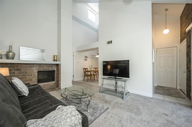 living room with a fireplace, carpet floors, and a high ceiling