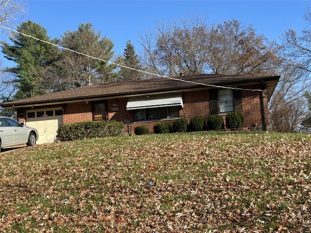 ranch-style home featuring a garage and a front lawn