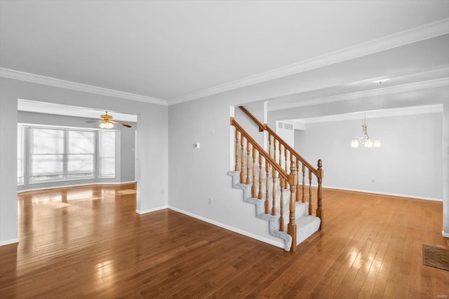 unfurnished living room with stairs, ornamental molding, wood-type flooring, and baseboards