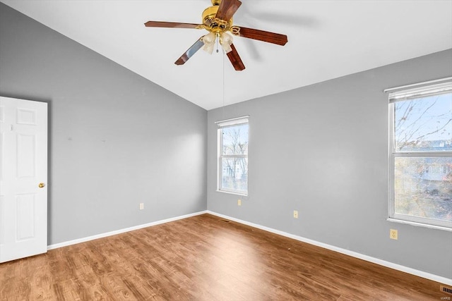 unfurnished room with lofted ceiling, ceiling fan, baseboards, and wood finished floors