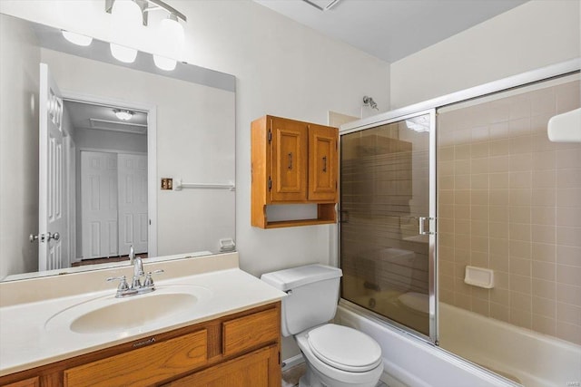 full bathroom with toilet, shower / bath combination with glass door, and vanity